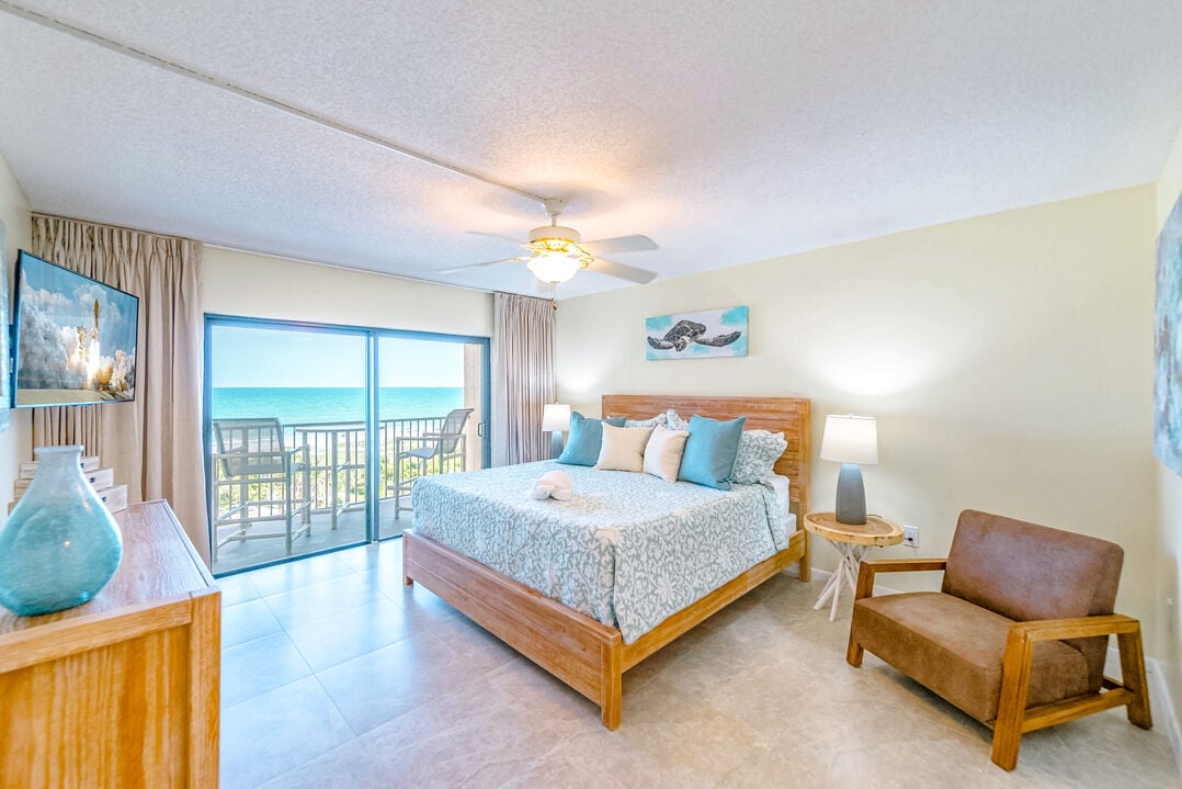 Serene master suite with a king bed, ocean views, and a private balcony.
