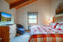 This bedroom is located on the top level. It is above the kitchen.