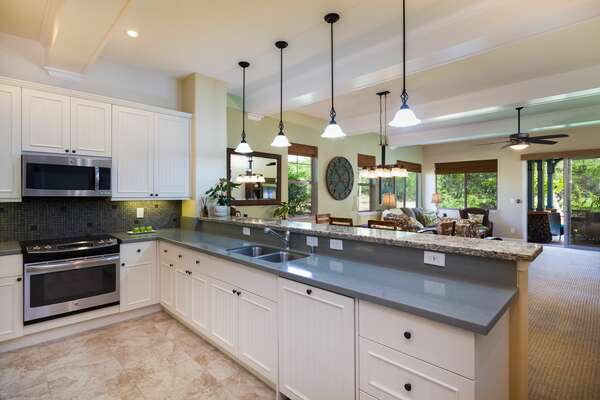 Kitchen Counter with Sink, Pendant Lamps, and Breakfast Bar