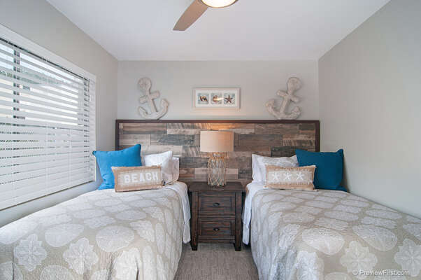 Guest Bedroom with 2 twin Beds and a nightstand between them.