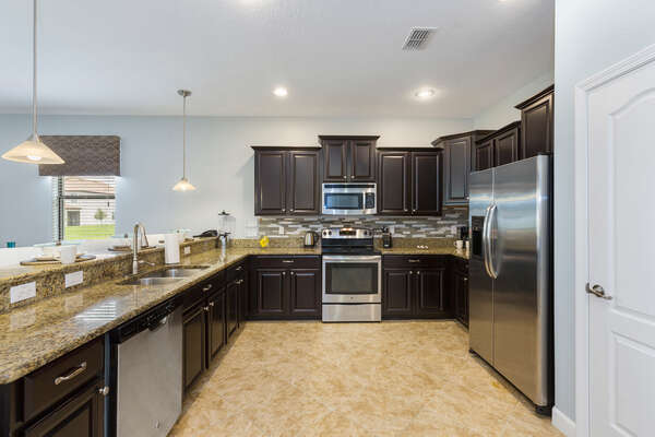 The kitchen has stainless steel appliances and granite counters