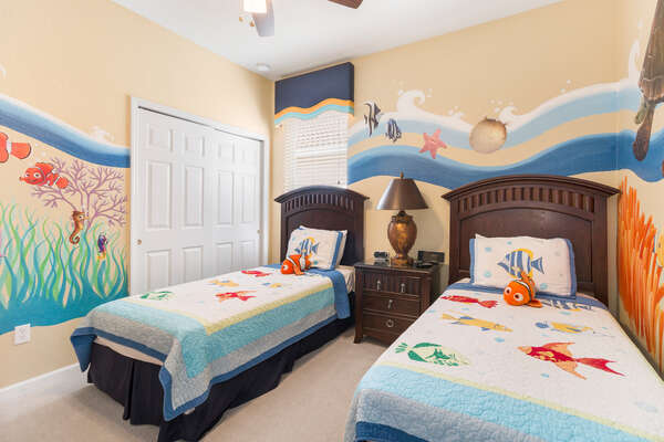 The fun kids bedroom features 2 twin beds
