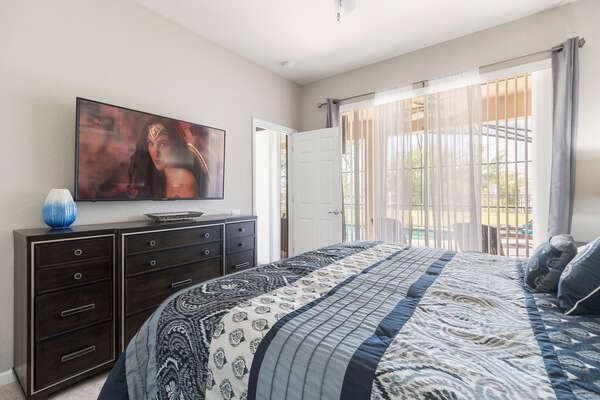 The master suite has access to the pool area and 55-inch SMART TV