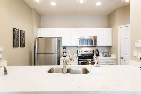 This kitchen features upgraded counter tops and stainless steel appliances