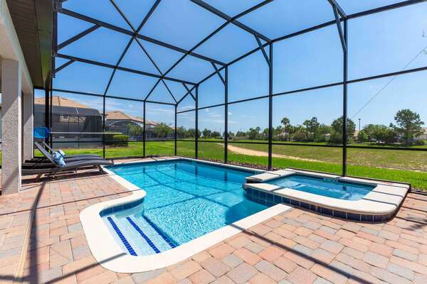 Relax in your own private screened pool with spillover spa