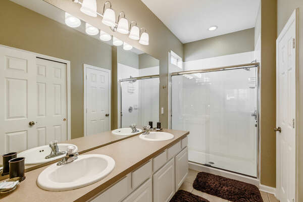 The en-suite bathroom has dual vanity and walk-in shower