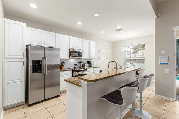 A fully equipped kitchen with breakfast bar