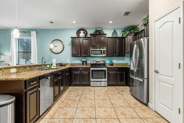 Stainless steel appliances, custom cabinetry, and granite countertops