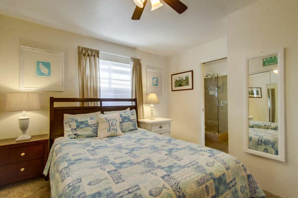 Bedroom with Large Bed, Nightstands, Table Lamps, and Ceiling Fan.