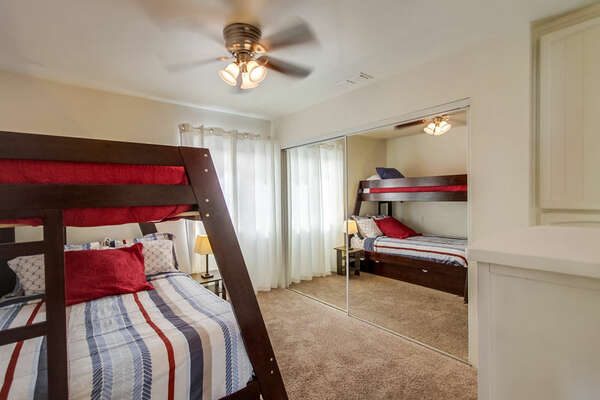 Bedroom with Bunker Bed, Ceiling Fan, and Mirror Closet Doors.