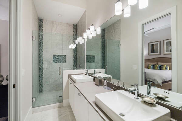 En-suite bathroom with dual vanity and glass walk-in shower