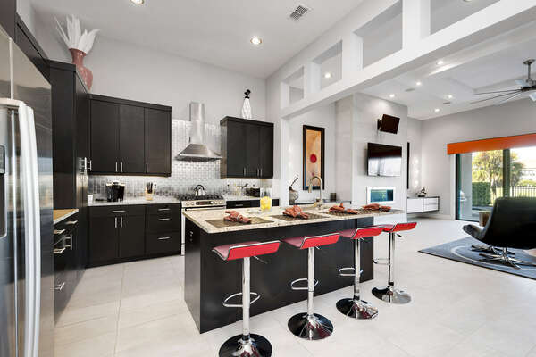 A gourmet kitchen to prepare family meals with a breakfast bar for 4