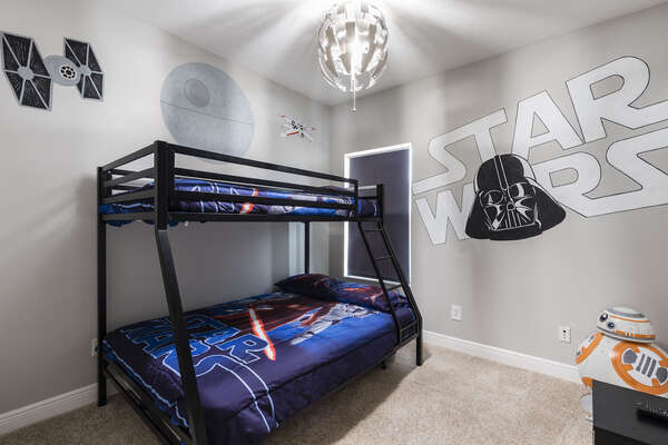 The kids will love this bedroom with a full/twin with trundle bunk bed and BB-8
