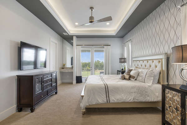 Sleep easy in this king bedroom with overhead ceiling fan and HDTV