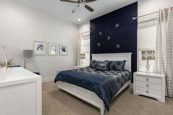 Calming navy and grey master bedroom with a king bed located on the ground floor