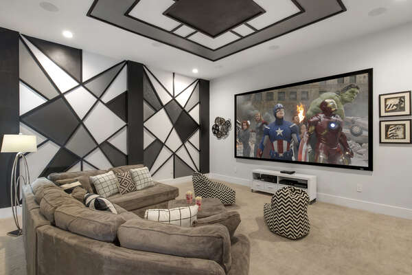 Modern meets retro in this theater room with a large projection screen