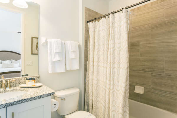 Ensuite bathroom featuring a tub shower combination