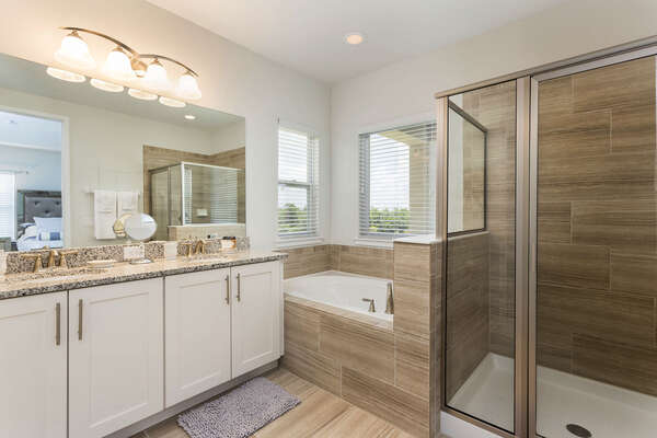 This bathroom features a tub and shower perfect for those who are looking to relax