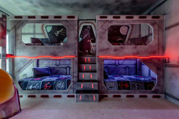 This galaxy-inspired bedroom has plenty of sleeping space for up to 8 children