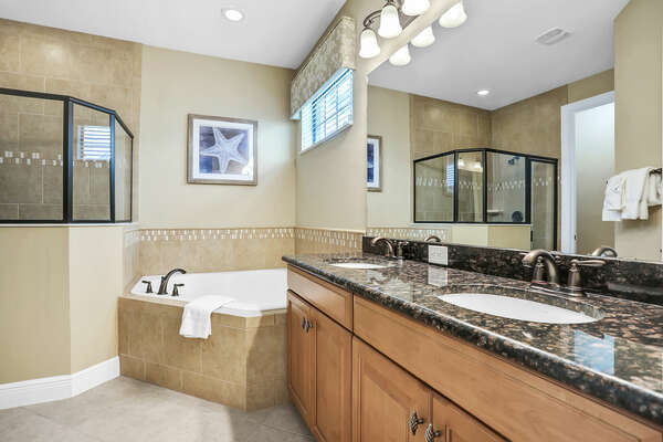 The master suite bathroom includes a walk in shower and garden tub