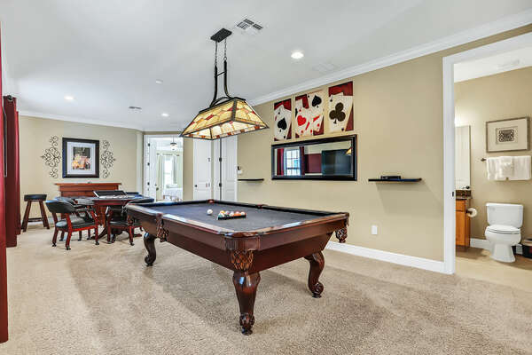 The entertainment loft includes a pool table, poker table, TV and game table