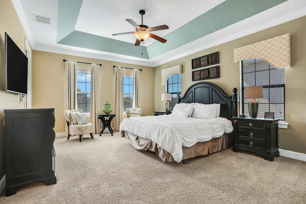 This second-floor master suite has a private balcony overlooking the golf course and pool