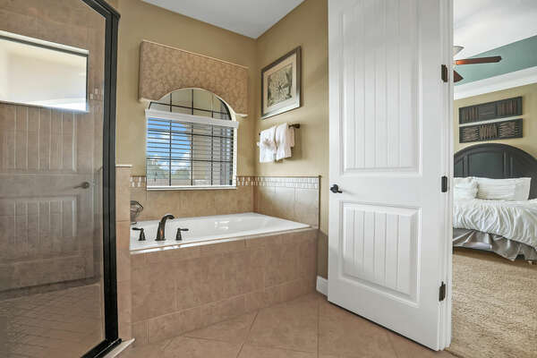 The master suite bathroom includes a garden tub and walk in shower