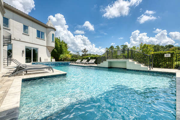 This expansive home has a large pool deck for your next luxury vacation