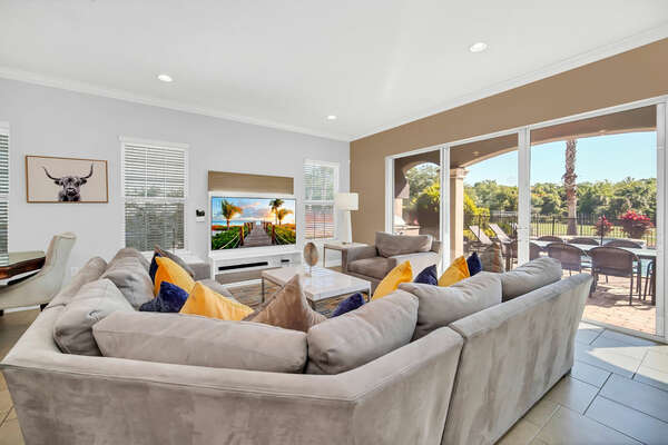 Step inside luxury with the beautiful living room offering views of the back patio and golf course