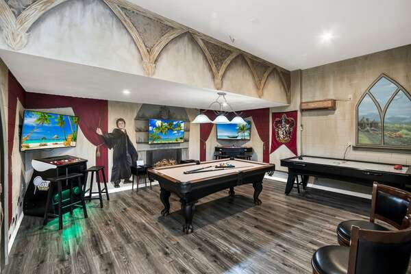The games room with a pool table, an air hockey table, a golden tee golf, and multi-arcade with 10,000 games