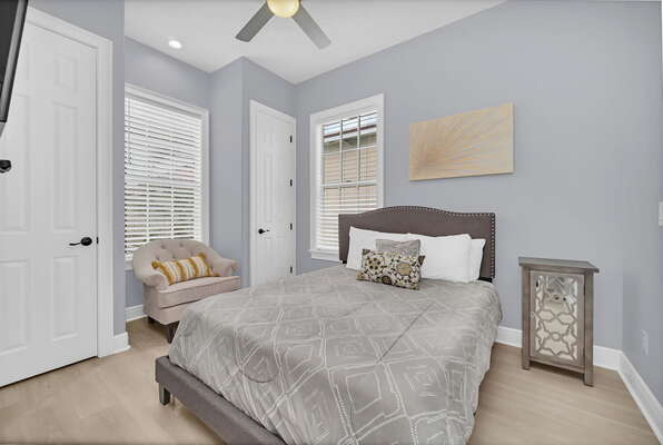 This upstairs bedroom features a comfortable Queen bed