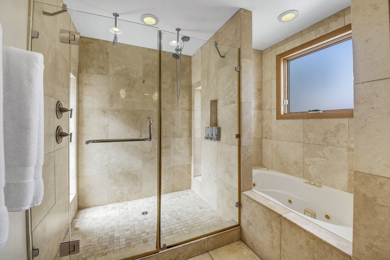 The en-suite master bathroom has dual sinks and a tiled shower.