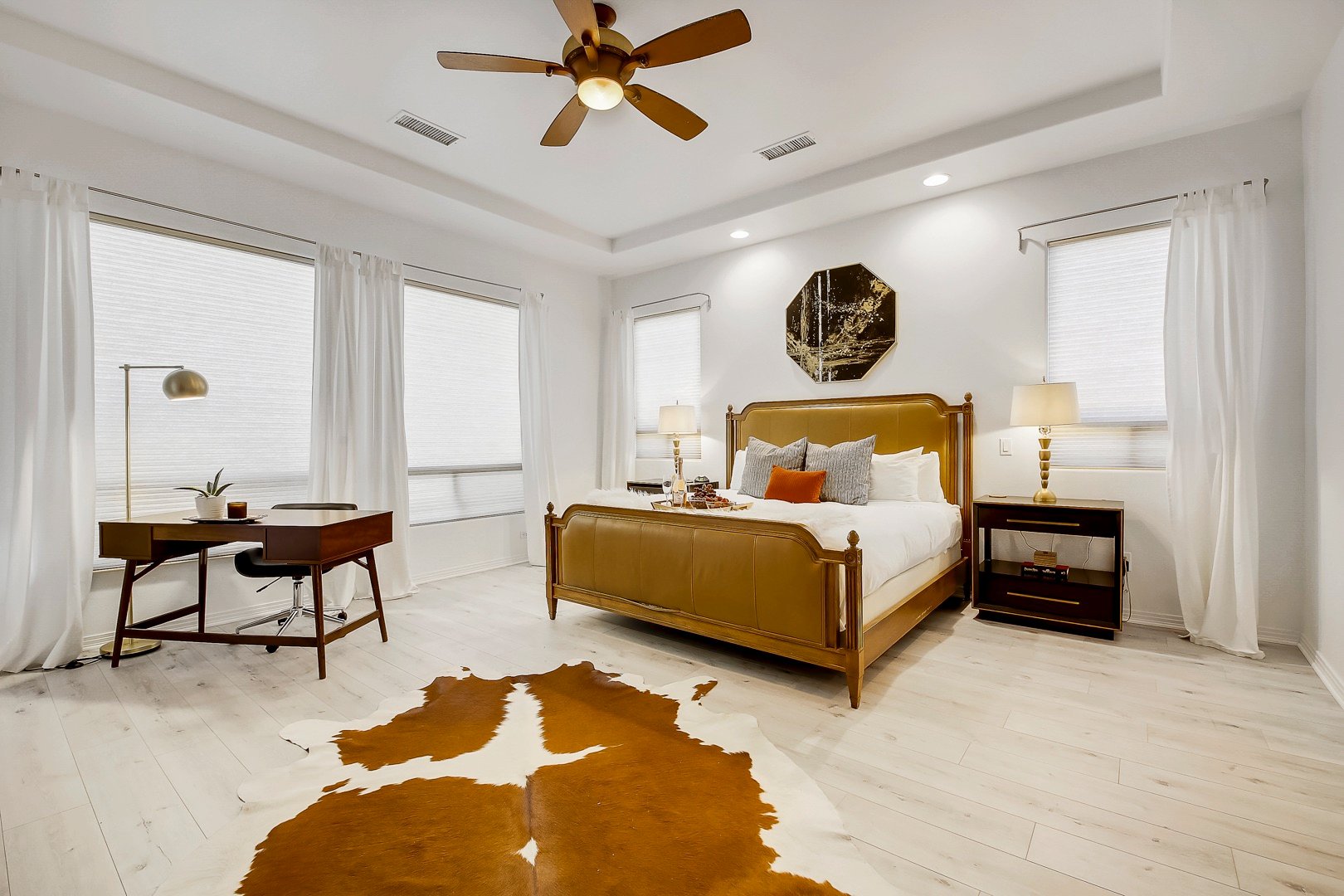 Master Suite 1 is located next to Suite 2 and features a King-sized Bed, HD television, switch-controlled ceiling fan, and large walk-in closet with access to the back patio.