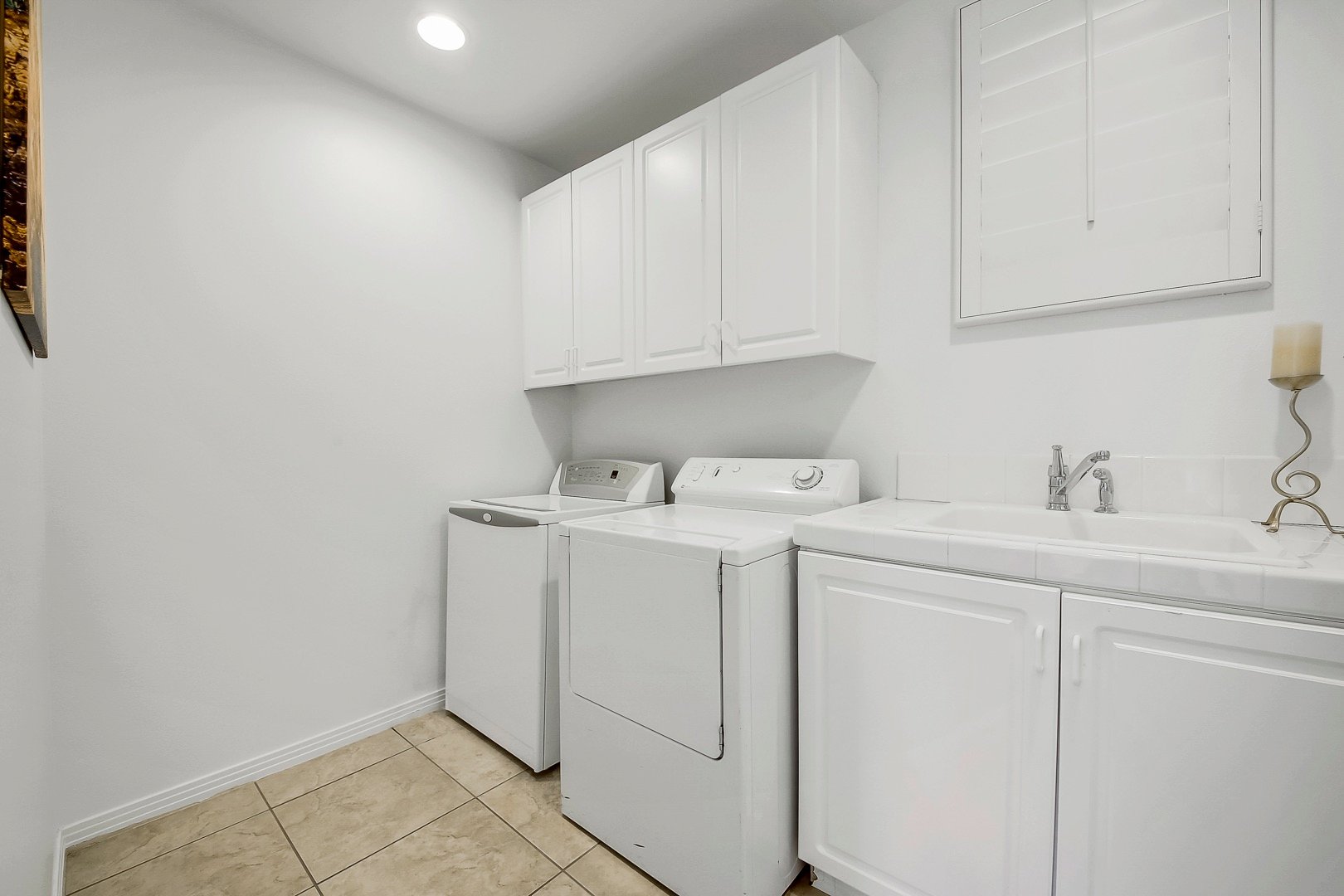 The laundry room is located across bedroom six and features a washer and dyer. Lots of cabinet space to store your clean clothes and a sink is readily available for your hand washing items.