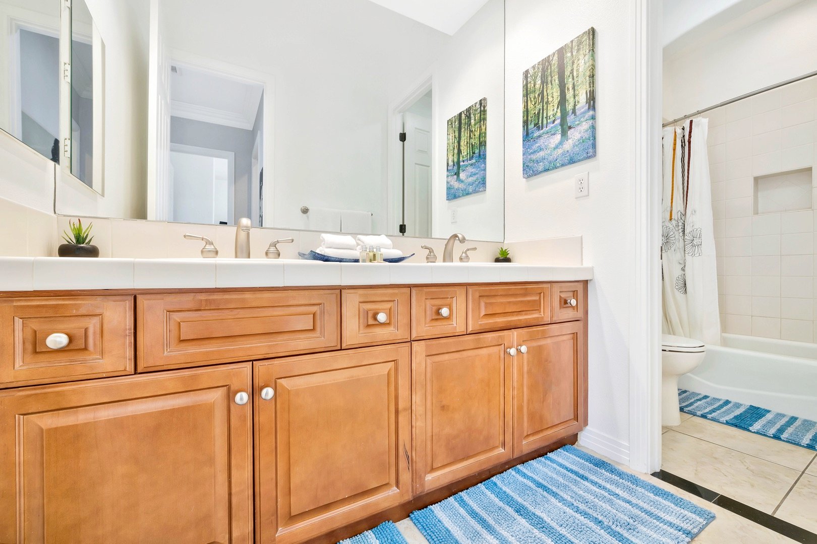 The hallway bathroom is across the hall from bedroom 5 and features a shower, bathtub combo and double-vanity sinks.