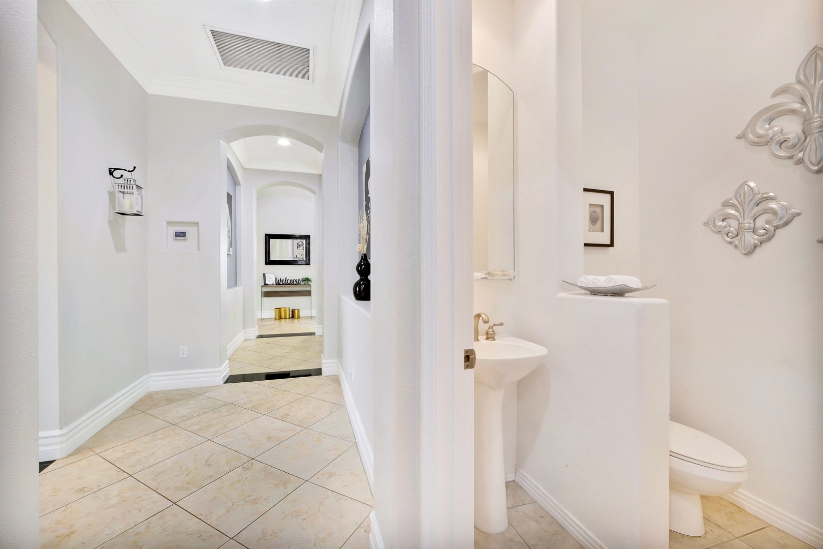 The powder room is conveniently located in the main hallway for your visiting guests to use.
