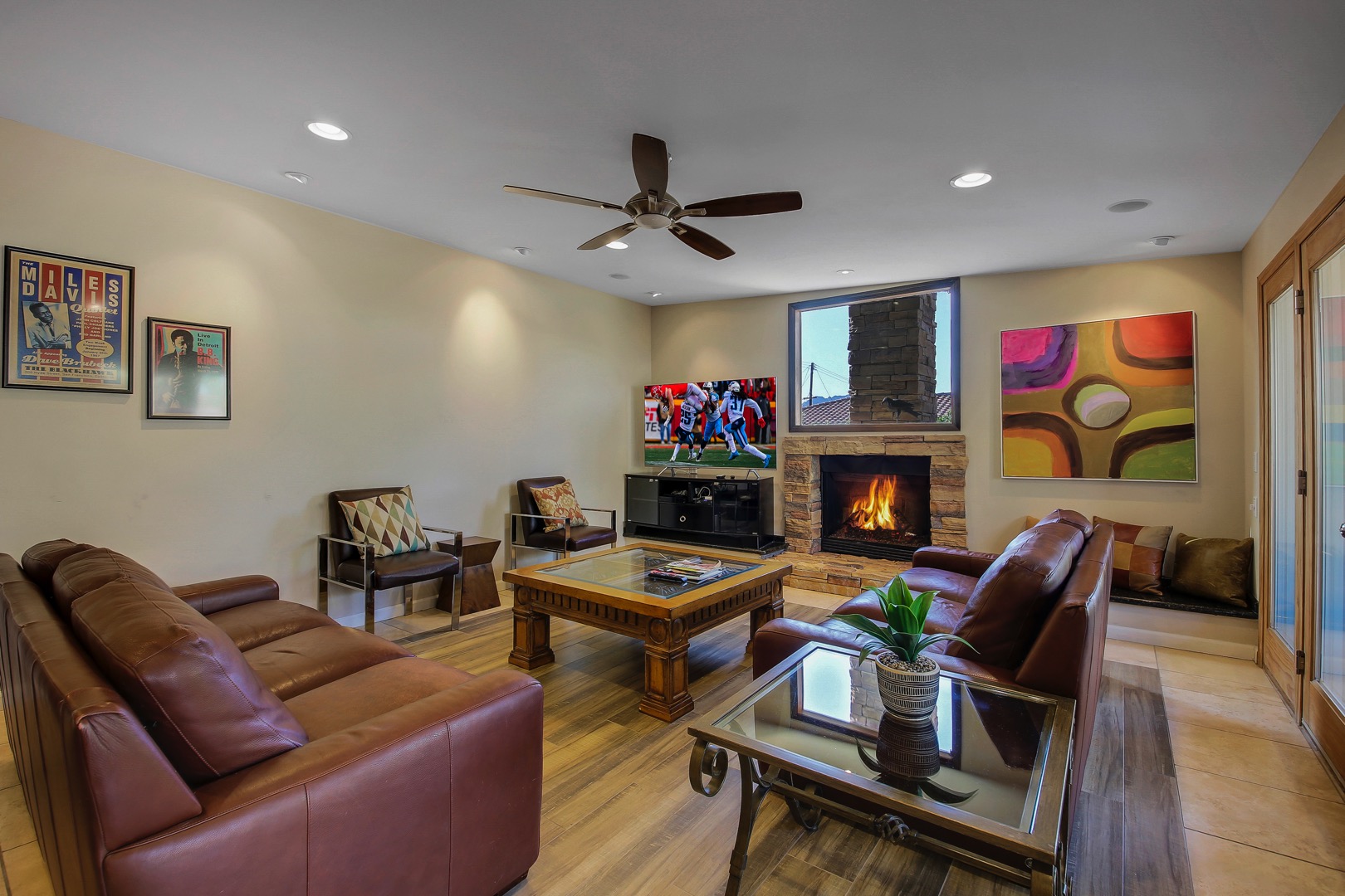 The family room features an HDTV, fireplace and french doors leading to a courtyard patio seating area.