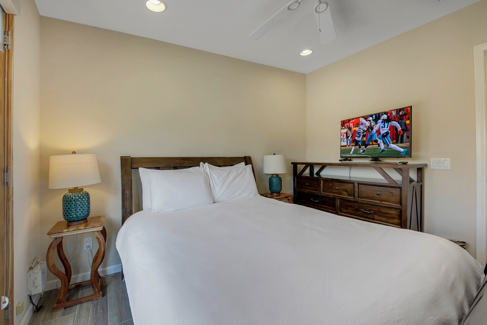 Bedroom 4 has a Queen-sized bed, Smart TV, with exterior doors to the horseshoe pit.