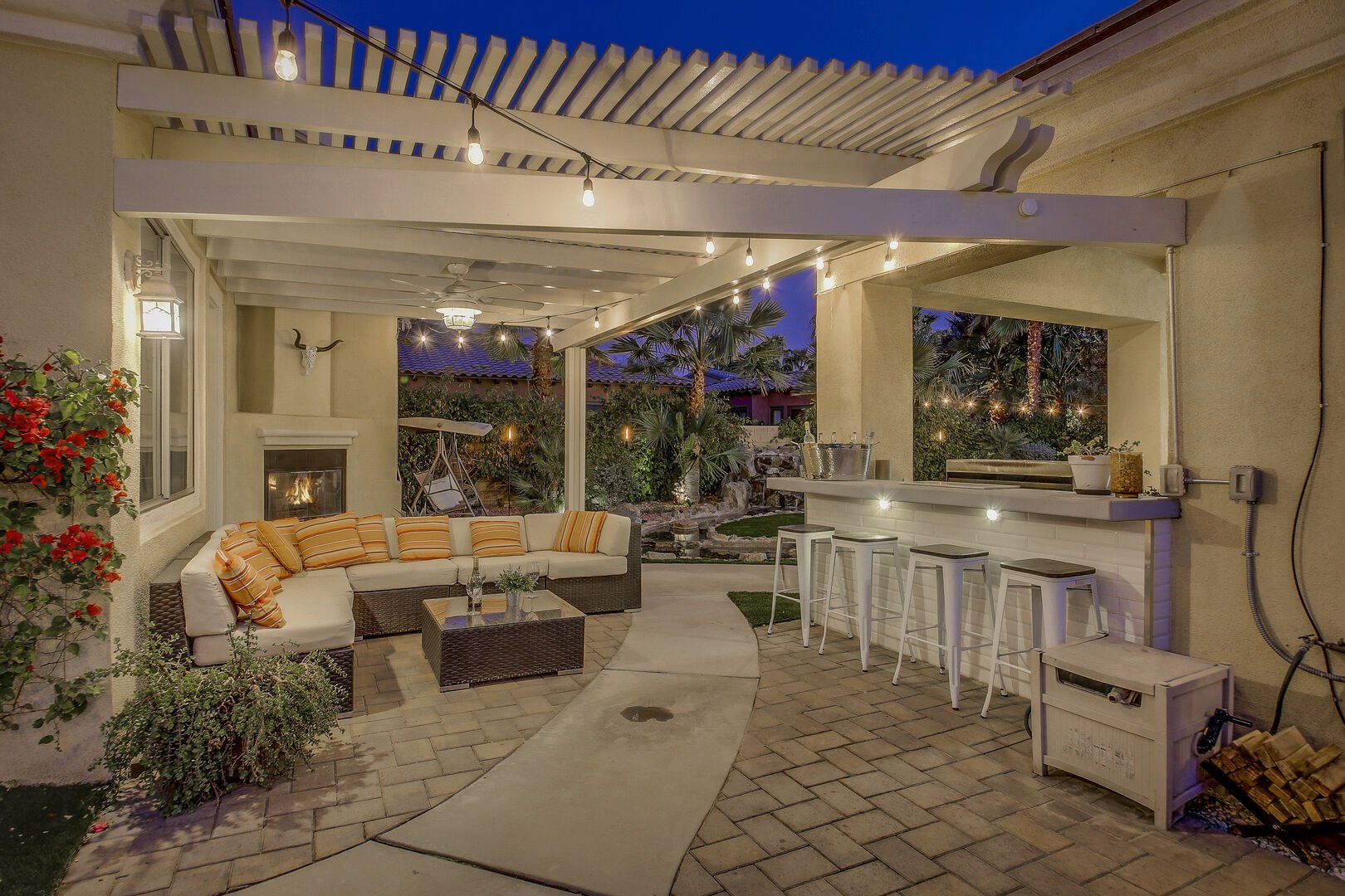 The perfect hang out spot is located near the pool. Room for the whole family on the comfortable patio couch and seating for four at the bar top.