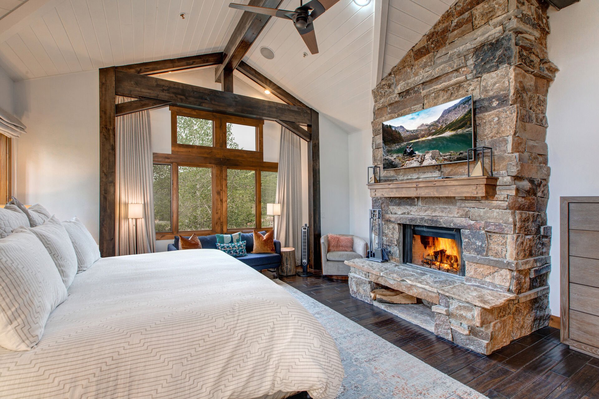 Main Level Master Bedroom with a King Bed, Wood Fireplace, Smart TV, Private Bath and Mountain Views