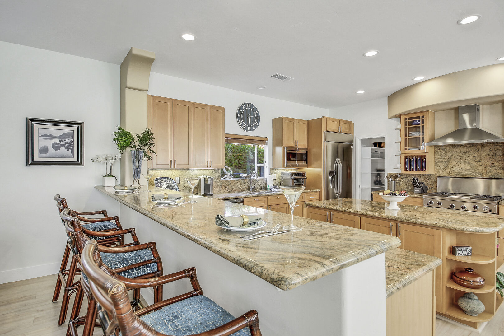 The granite countertops include bar height dining with seating for three.