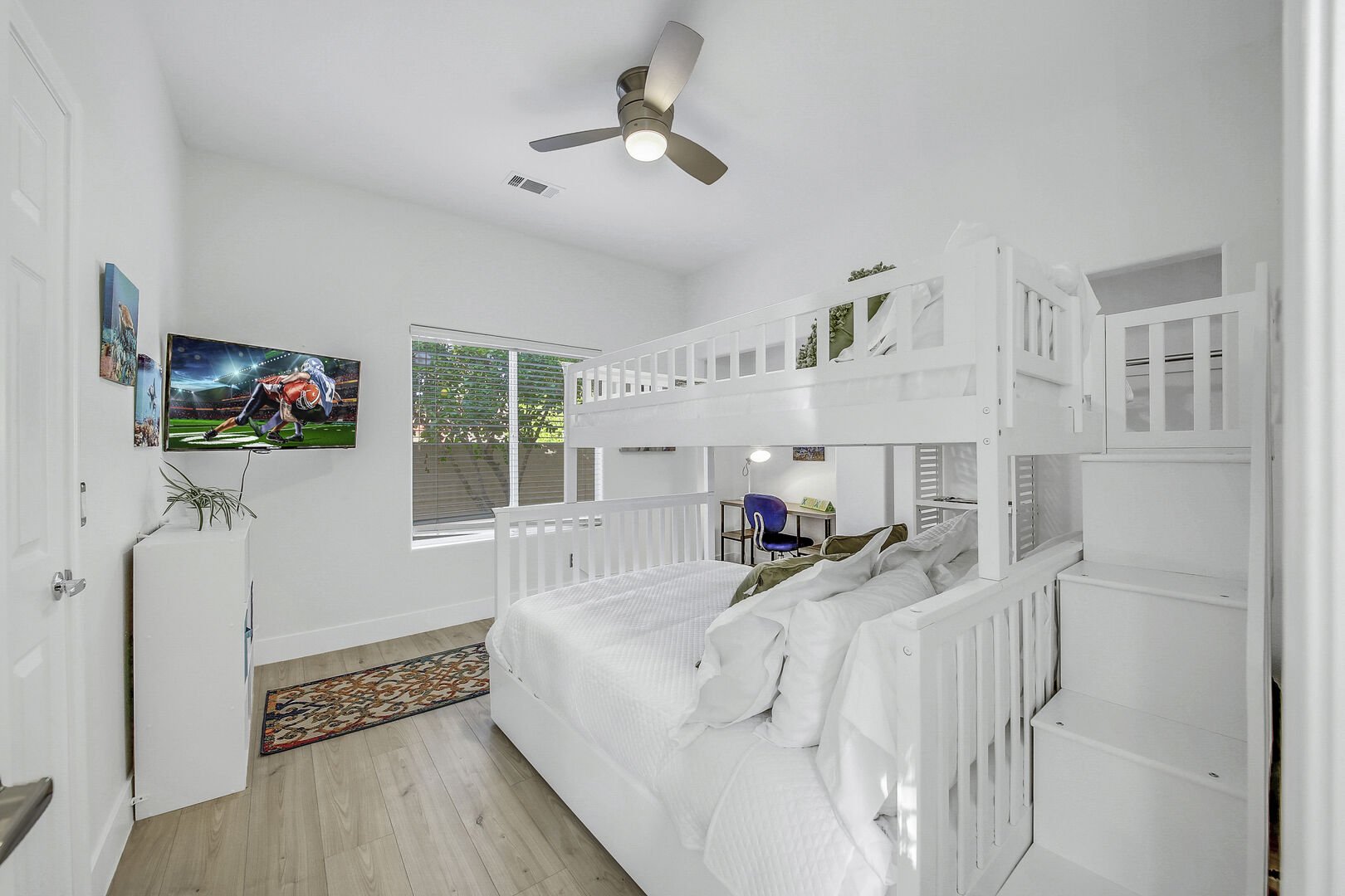 Bedroom 4 is located next to bedroom 3 and features a Twin Over Full with Twin Trundle Bunk Bed and a 32-inch HiSense with Roku Smart television.