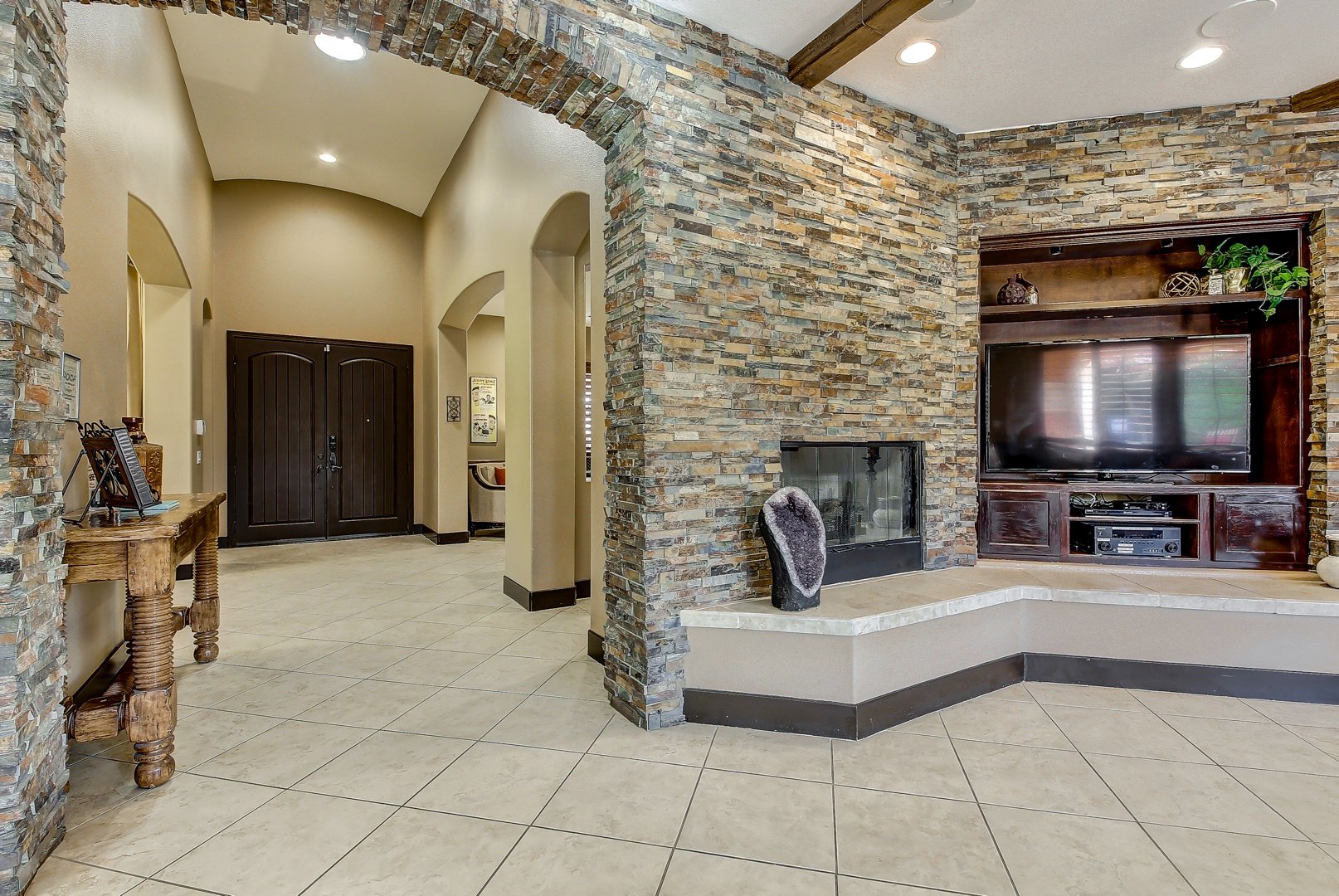 Custom stone walls and entryway with 10 ft ceilings throughout the house.