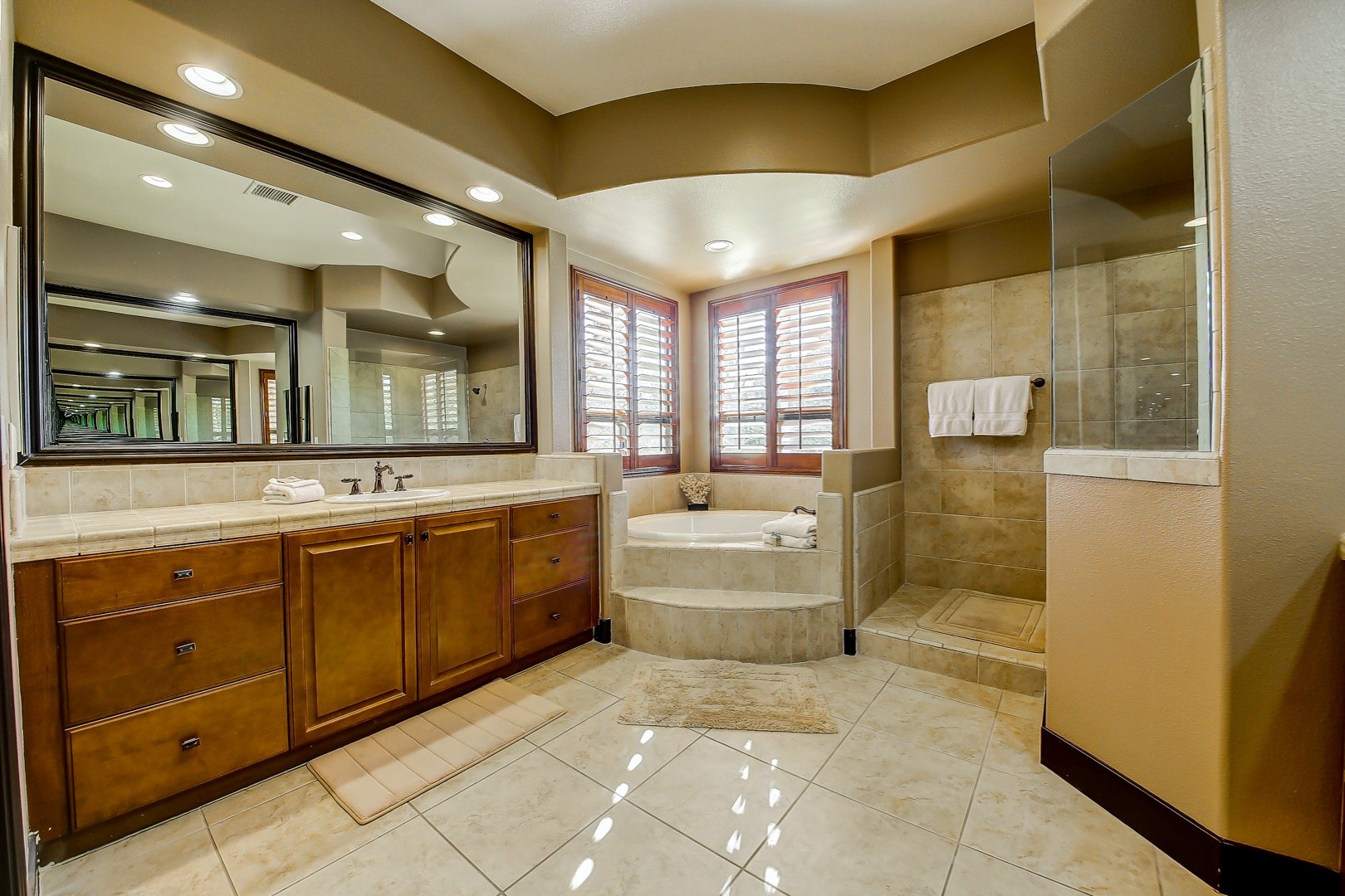 Master Suite 1 bathroom features a soaking tub, tile shower, and his and her vanity sinks. 