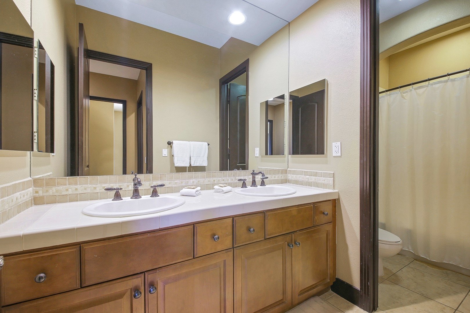 Bathroom 3 is located across bedroom 4 and features a shower, bathtub combo and double-vanity sinks. It may be used to service bedrooms 3 and 4.