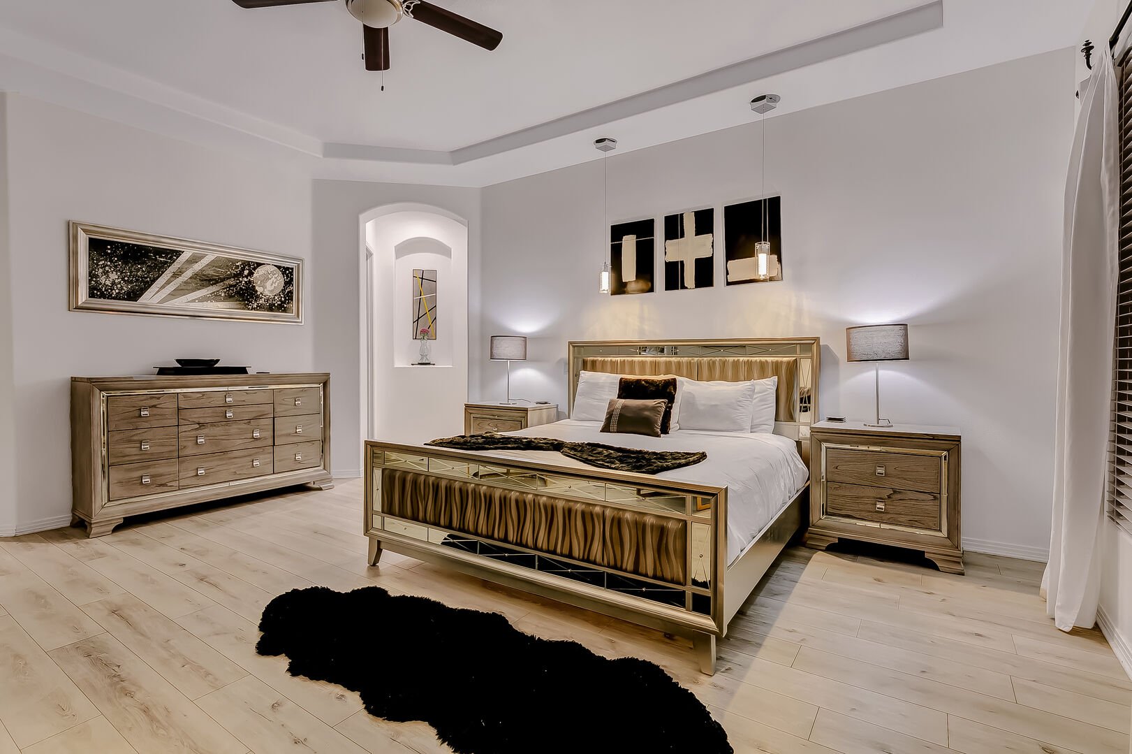 Master bedroom features a king size bed, desk, seating area, large HDTV, and remote-controlled ceiling fan!