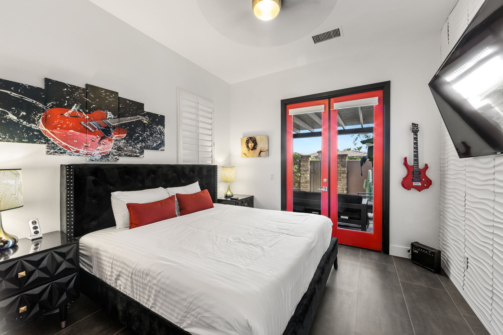 Bedroom 5 has a King-sized bed, a separate entry from the landscaped courtyard, & TV.