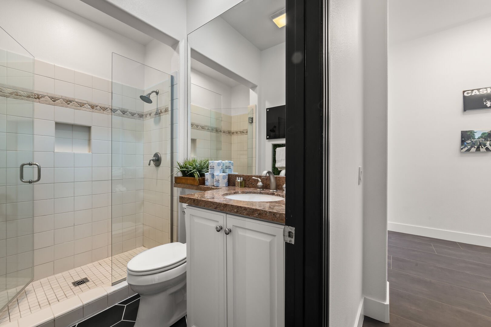The private en Suite bathroom features a tile shower and granite countertop.