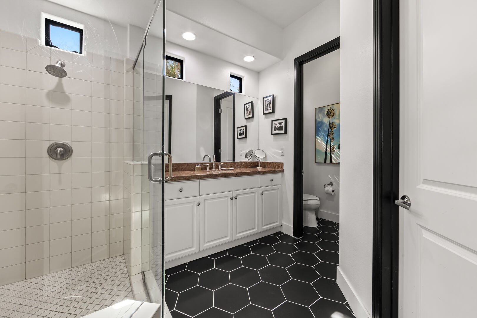 The private en Suite bathroom features a tile shower and granite countertop.