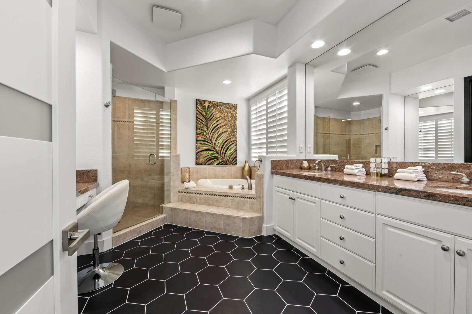 The Master Suite bathroom features a soaking tub, a tile shower with a built-in raised bench, double vanity sinks, and makeup counter.